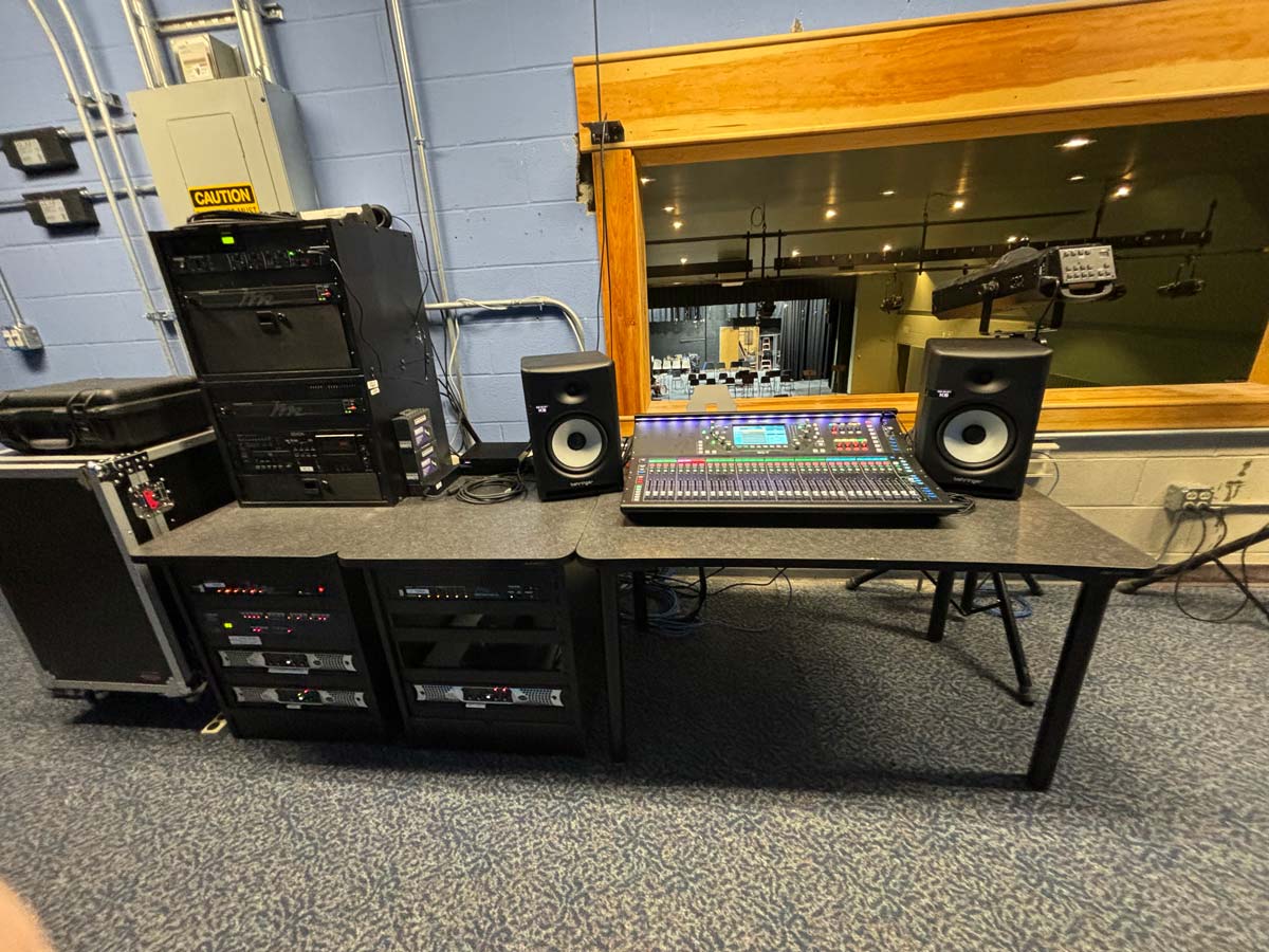 Professional audio control room featuring a digital mixing console, studio monitors, and rack-mounted gear, installed and supported by Pro Sound Associates.